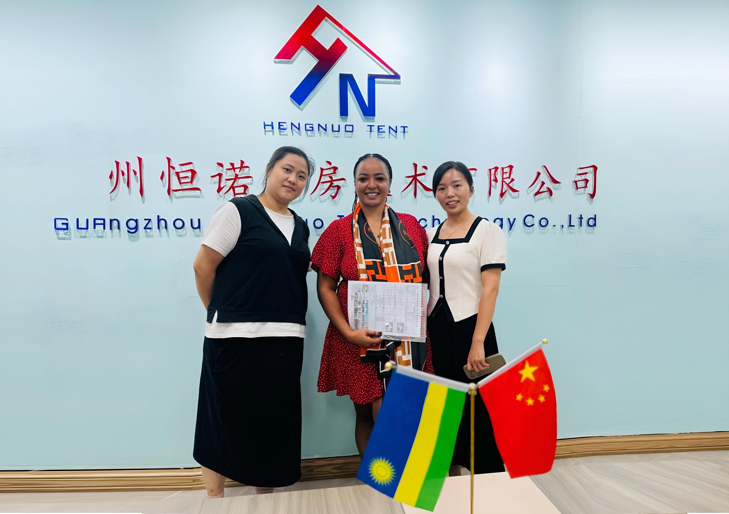 CD Business Group visiting the Hengnuo Tent factory in Guangzhou, with Rwandan and Chinese flags on the table