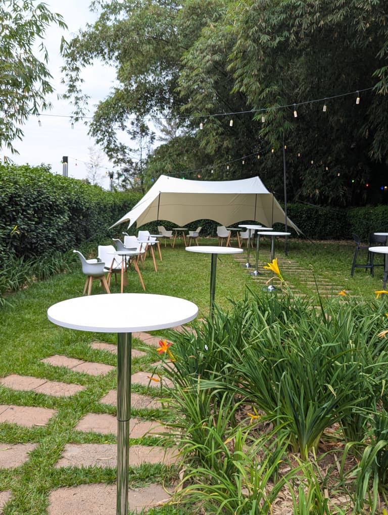 Garden reception under a stretch tent with string lights