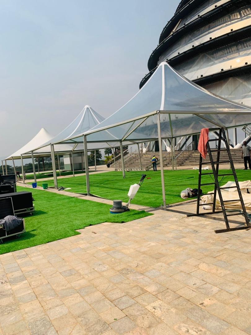 Crew installing transparent pagoda tents and artificial grass at the Kigali Convention Centre